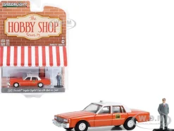 1981 Chevrolet Impala Capitol Cab Taxi Orange with White Top and Man in Suit Figure The Hobby Shop Series 15 1/64 Diecast Model Car Greenlight 97150B