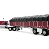 Peterbilt 389 with 63" Flat Top Sleeper and 53’ Wilson Roadbrute Flatbed Trailer with Covered Wagon Maroon with White Stripes 1/64 Diecast Model by DCP/First Gear